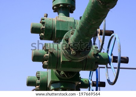 petroleum machinery pipe and handwheel, closeup of photo