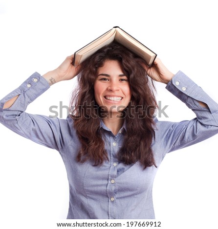 Happy girl with a book on her head