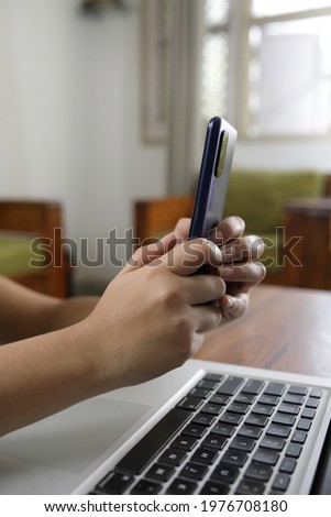 hand close up with computer key board and mobile phone