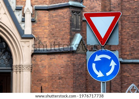 the sign is circular motion and give way on the background of the building, close-up