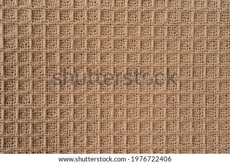 Fabric natural texture as background. Beige natural cotton waffle fabric texture as background, macro view in high resolution