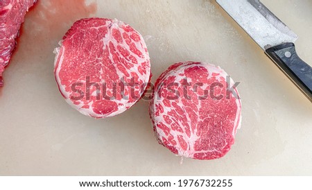 Raw hump beef sliced on white cutting  board. Royalty-Free Stock Photo #1976732255