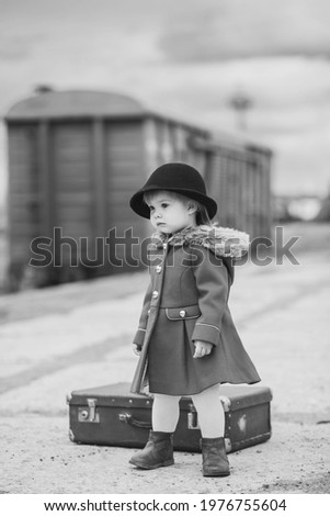 
Retro photo of a baby girl who is waiting for a train