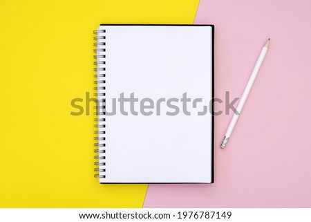 Spiral notebook mockup, journal, planner mock up, top view on yellow pink background, pencil, education, writing, diary concept.