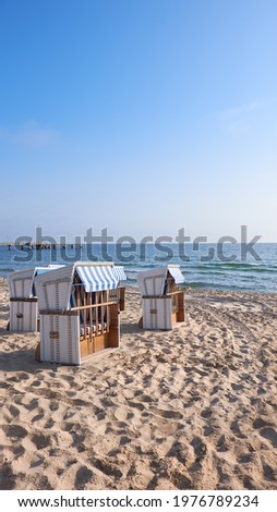 Banner, beach and beach chairs in Rugen, an island on the coast of Baltic Sea in Northern Germany. Vertical banner, panoramic image