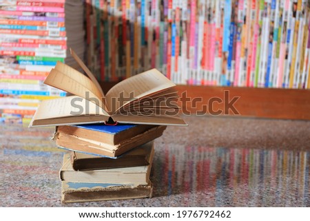 Close-up of open books on a pile of old books selective focus and shallow depth of field
