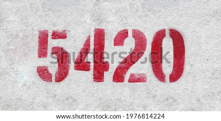 Red Number 5420 on the white wall. Spray paint.