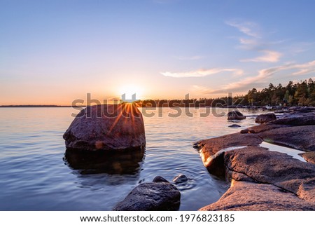 Rocky coast of the gulf of finland at sunset. Summer in Finland Royalty-Free Stock Photo #1976823185