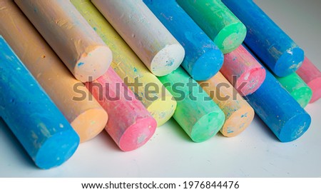 colored chalks arranged diagonally over a white background
