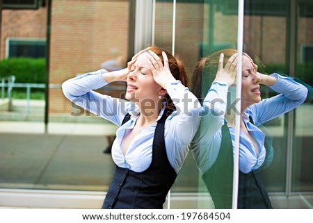 Closeup portrait unhappy young business woman, head on window, bothered by mistake having bad headache isolated background corporate office. Negative human emotion, facial expression life reaction