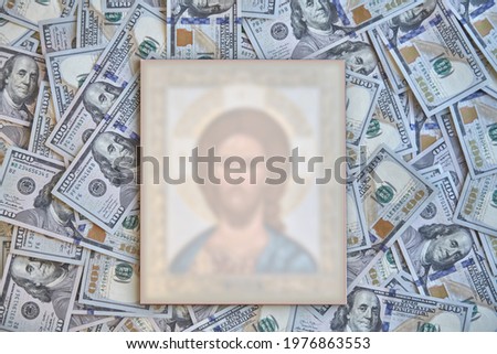 silhouette of a religious icon against a background of hundred-dollar bills, the concept of bribes