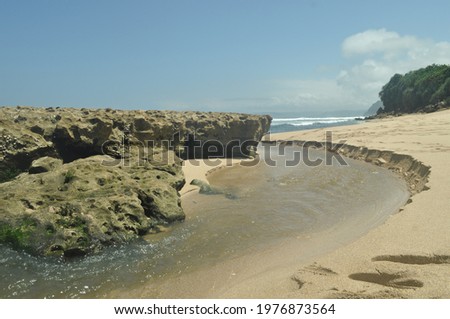 Beach with rocks and white sand. Beautiful Sanggar Beach in Tulung Agung, East Java, Indonesia. These photos are also great for outlines, quotes, backgrounds, artwork or traveling.
