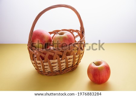 Large ripe apples in a wicker basket.