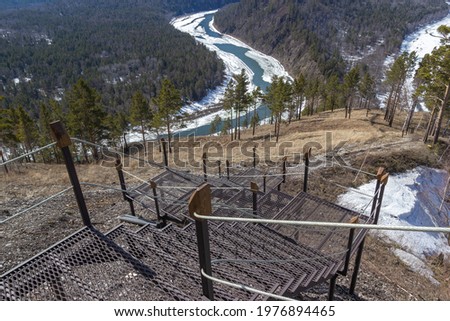 View of the river canyon from the equipped trail with an iron staircase to the mountain. Tourism concept.