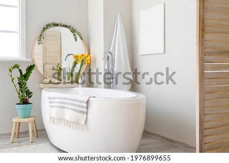 Interior of bathroom with fresh flowers