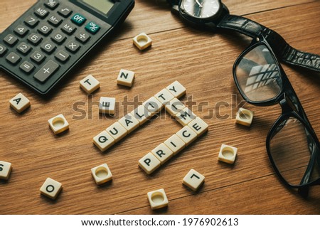 Business concept. Alphabetical crossword of Quality,Time and Price.