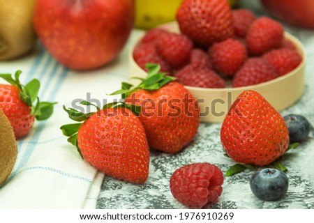 Fresh and ripe strawberries, close-up outdoors. Sweet and juicy strawberries as a background with space for text. Organic food concept