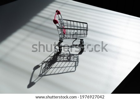 Shopping trolley on white table.