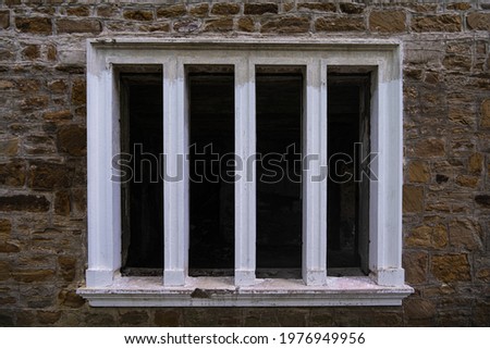a window without glass in an abandoned house from the early 20th century