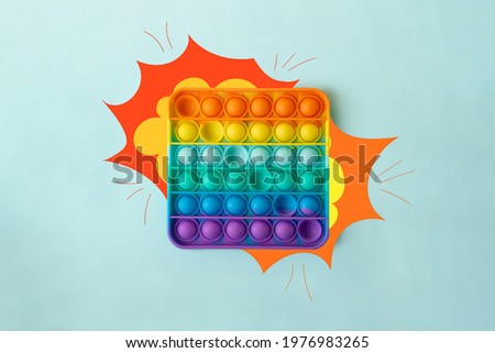 Top view of the new sensory toy - rainbow pop it with a painted explosion on sides like the sound it makes.Antistress toy for children and adult.Colorful toy. Royalty-Free Stock Photo #1976983265