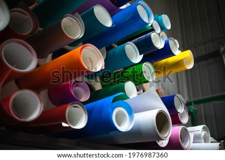 Rolls of vinyl film for use in advertising and pasting vehicles, are in production Royalty-Free Stock Photo #1976987360