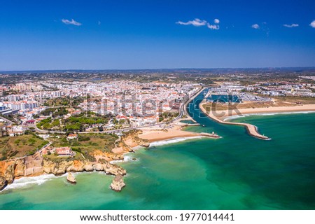 Aerial view of golden coast cliffs of portuguese southern beaches in Lagos City, Algarve, Portugal. River and marine. Royalty-Free Stock Photo #1977014441