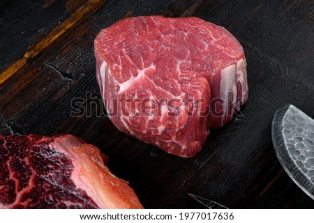 Fresh raw fillet minion steaks marbled beef with rosemary and garlic set, on old dark  wooden table background