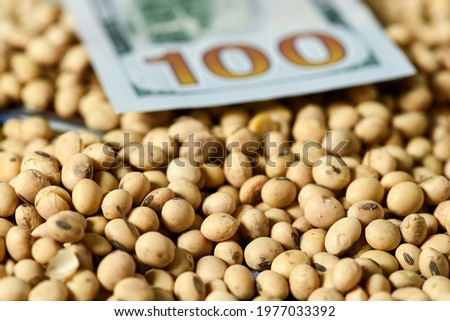 Dollars banknotes and coins and soy beans, commoditi value concept.