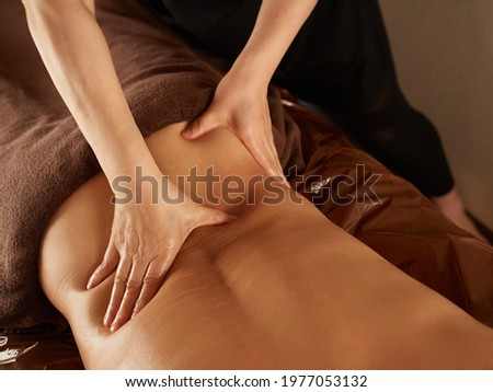 Asian man receiving a waist massage Royalty-Free Stock Photo #1977053132