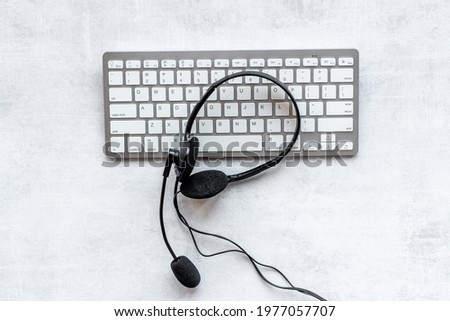 Voip headset and computer laptop on offise desk. Commenication it support call center