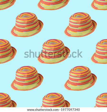 A pattern of colorful summer hats on a blue background. Protective headdress.