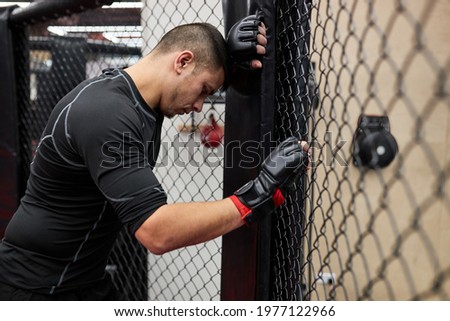 Side view on strong tired man spend time in gym practicing boxing, have rest, take a break. Training sports motivation concept