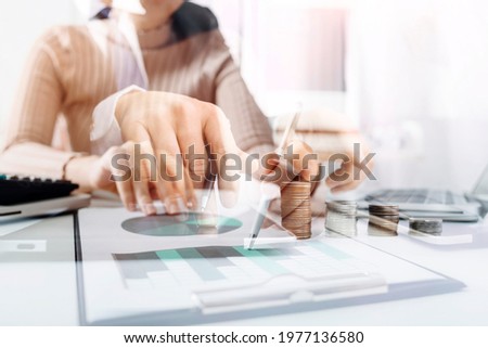 Business women reading document on office with tablet and graph financial diagram.Teamwork workplace strategy Concept.