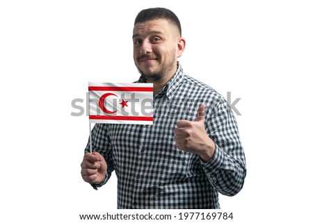 White guy holding a flag of Turkish Republic of Northern Cyprus and shows the class by hand isolated on a white background. Like for Turkish Republic of Northern Cyprus.