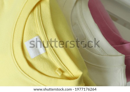 Yellow, pink and white sweatshirts, close up