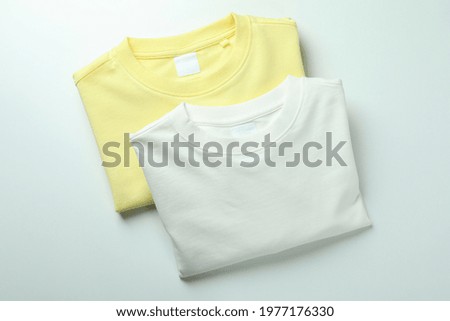 White and yellow sweatshirts on white background