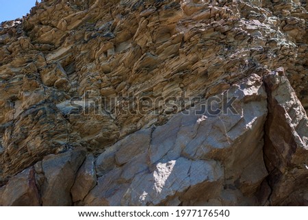 The structure of the rocky rock. A mountain of rock formations. Stone background. Close-up macro photography, selective focusing.