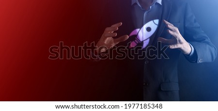 An empty workpiece. A businessman in a suit on a black background holds his hands protective gesture. A gesture of care and patronage