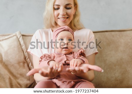 Portrait of mother and child laughing and playing