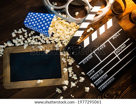 Cinema concept of vintage film reels, clapperboard and other tools