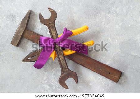 Craft gift with old tool on stone background. Fathers day concept. Flat lay. hammer, pliers and spanner.