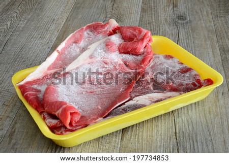 steaks of red meat frozen beef in food tray