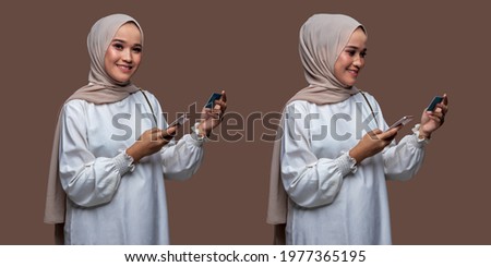 Beautiful woman in hijab was holding cellphone and credit card