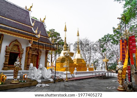 Wat Phra That Doi Tung, famous temple north of Thailand. Thai Wording at center-bottom of image that left side means PLEASE TAKE OFF YOUR SHOES and right side means LADY NO ENTRY.