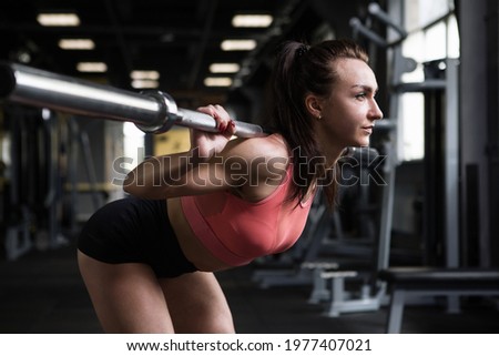 Female athlete doing goodmorning exercise at functional training gym Royalty-Free Stock Photo #1977407021