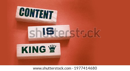 Content is king words on wooden blocks on dark grey background. Copywriting storytelling concept.