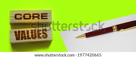 core values words on wooden blocks on yellow background. Business ethics concept.