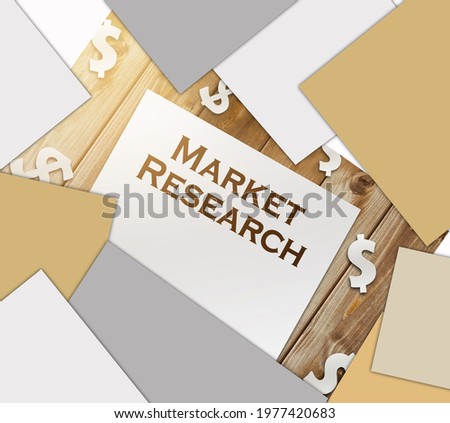 Market Research words on page and paper dollar signs around on wooden table. business concept