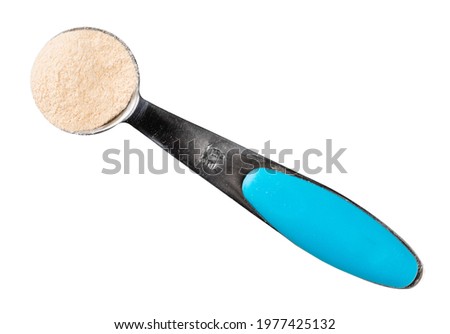 top view of apple pectin powder in measuring spoon cutout on white background