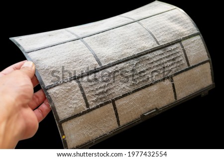 Dusty and dirty air conditioner filter on women hand 